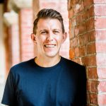 Headshot by brick wall